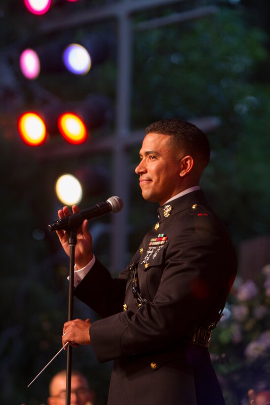 Warrant Officer Andres Navarro, officer in charge of the 3rd Marine Aircraft Wing Band, addresses a crowd gathered for a performance at the Disneyland Resort in Anaheim, Calif., July 4. The band performed several times during the Independence Day celebration, including the park’s flag retreat and a concert at the Big Thunder Ranch Jamboree stage.