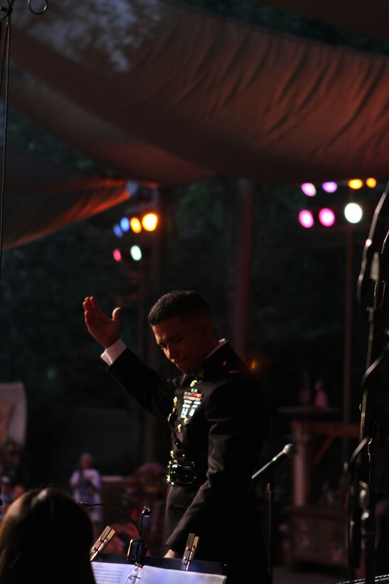 Warrant Officer Andres Navarro, officer in charge of the 3rd Marine Aircraft Wing Band, receives applause on behalf of the concert band during a performance at the Disneyland Resort in Anaheim, Calif., July 4. In addition to the concert at the Big Thunder Ranch Jamboree stage, the 3rd MAW Band performed several times throughout the park during an Independence Day celebration. This year marks the third year the Disneyland Resort has featured the Marines of the 3rd MAW Band during their annual Independence Day celebration.