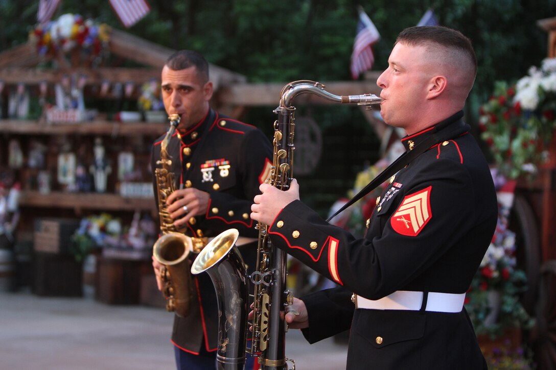 Staff Sgt. Mark Pellon, left, and Sgt. Brandon Johnson, right, both musicians with the 3rd Marine Aircraft Wing Band, play saxophones during a performance with the 3rd MAW party band at the Disneyland Resort in Anaheim, Calif., July 4. The Independence Day concert featured performances by both the concert band and the party band, and entertained crowds with patriotic music for Independence Day, as well as modern favorites for the crowd to interact and sing along. 