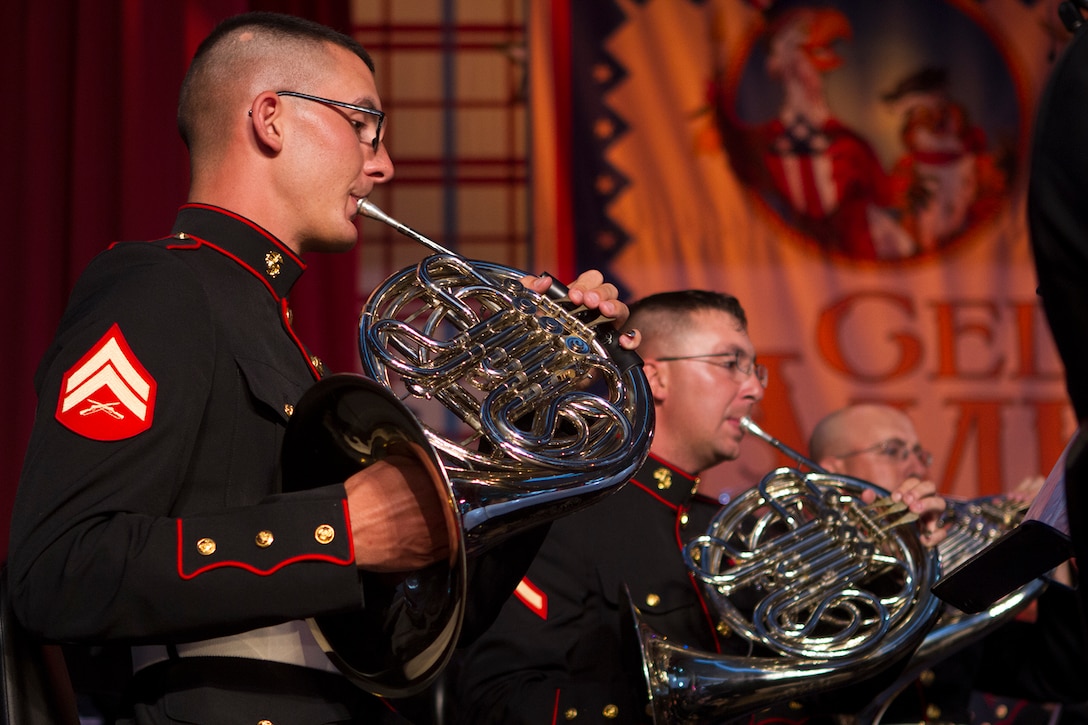 Cpl. Jim Peterman, left, musician with the 3rd Marine Aircraft Wing Band, plays the French horn during an Independence Day concert at the Disneyland Resort in Anaheim, Calif., July 4.  The concert featured patriotic melodies and crowd favorites, including an interactive sing-along with the 3rd MAW party band. This year marks the band’s third year being featured during Disneyland’s Independence Day celebration.