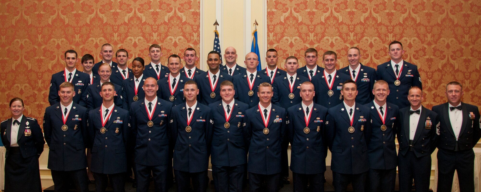 Airman Leadership School Class 14-F poses for a photo with Col. Tracey Hayes, 90th Missile Wing commander; Chief Master Sgt. Samuel Couch, 90th MW command chief; and Chief Master Sgt. Marc Vogt, 90th Maintenance Group superintendent of quality assurance, in the Little America Hotel & Resort in Cheyenne, Wyo., July 2, 2014. Airmen in the class graduated shortly after in a ceremony held in their honor. Enlisted Airmen must graduate ALS before they can supervise other Airmen. (U.S. Air Force photo by Airman 1st Class Jason Wiese)