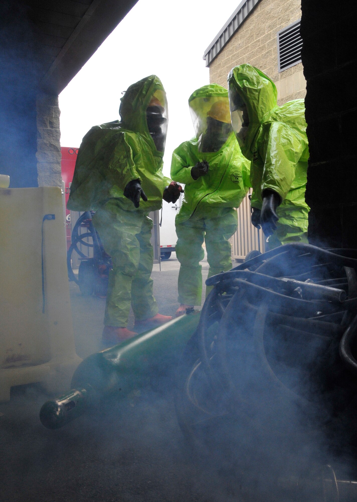 Department of Defense first responders assess a "hazardous" leak during a training exercise at Fairchild Air Force Base, Washington, June 26, 2014. Firefighters from across the Air Force came to Fairchild to attend a hazardous materials technical training course designed to improve weapons of mass destruction and HazMat incident response capability for Fairchild and the surrounding community. After the 64-hour course, students  received certifications recognized by the International Fire Service Accreditation Congress. (U.S. Air Force photo by Senior Airman Mary O'Dell/Released)