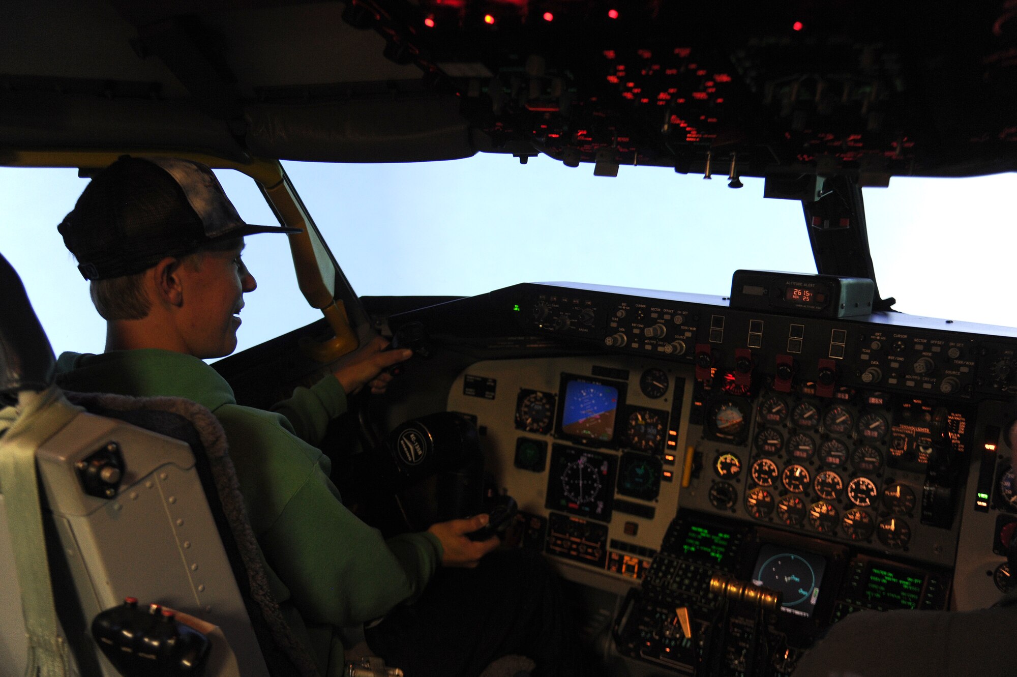 A student from the Spokane Community College lands a KC-135 Stratotanker in a flight simulator during a base tour at Fairchild Air Force Base, Washington, July 2, 2014. The students received a base tour with stops at aerospace physiology, the control tower, a rescue helicopter static display, the base headquarters and the KC-135 Stratotanker flight simulator. (U.S. Air Force photo by Airman 1st Class Janelle Patiño/Released)