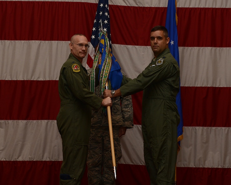 Lt. Col. Jason Horton assumes command of the 96th Bomb Squadron from Col. Michael Adderley, 2nd Operations Group commander, during a change of command ceremony at Barksdale Air Force Base, La., July 7, 2014. Before taking command of the 96th BS, Horton was an instructor pilot and Director of Operations for the 2nd Operations Support Squadron. (U.S. Air Force photo/Senior Airman Benjamin Gonsier)