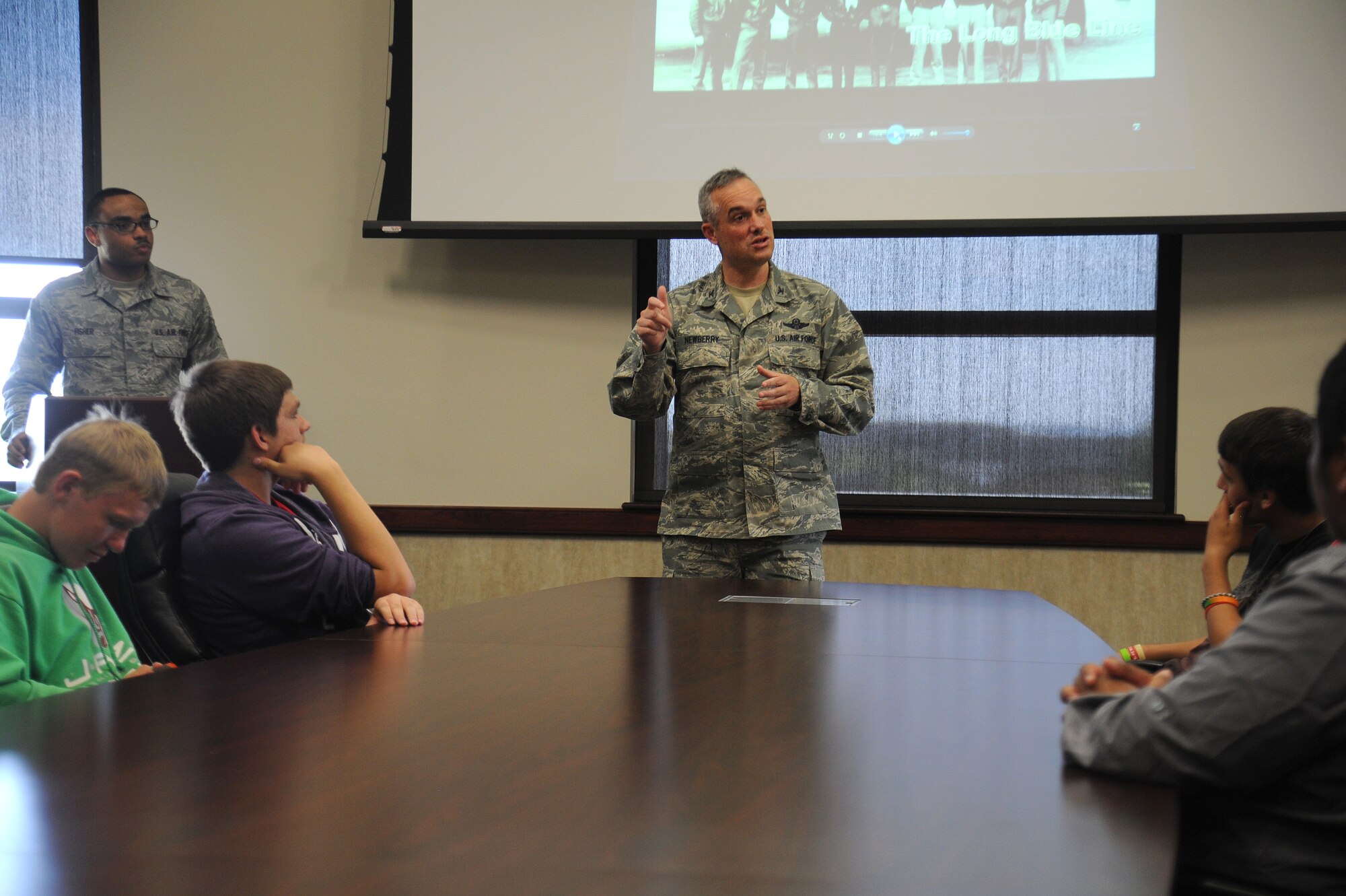 Col. Brian Newberry speaks with students from Spokane Community College during a base tour at Fairchild Air Force Base, Washington, July 2, 2014. Newberry welcomed and thanked the students for taking the time to visit. He is the 92nd Air Refueling Wing commander. (U.S. Air Force photo by Airman 1st Class Janelle Patiño/Released)