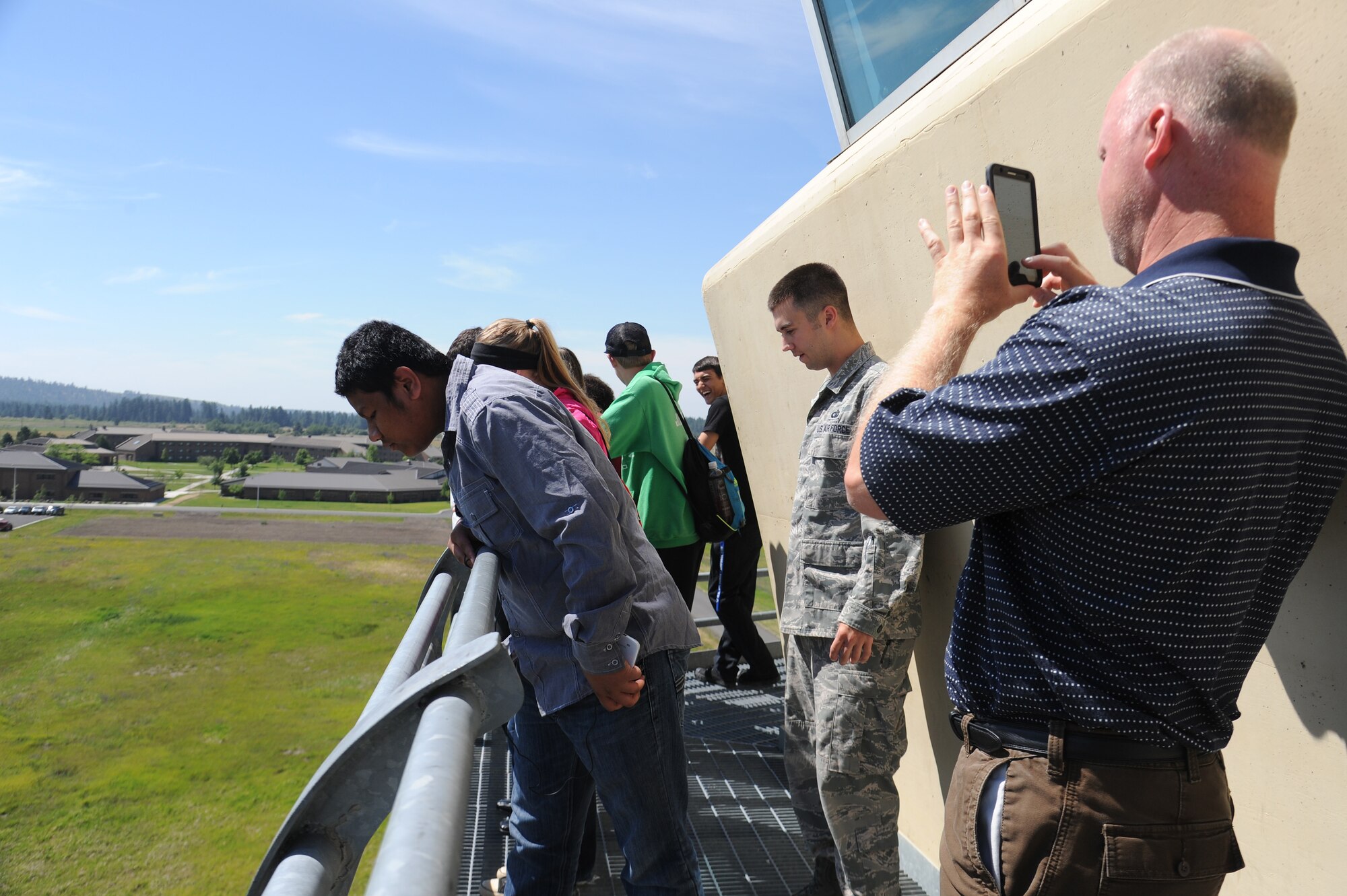 Students and teachers from Spokane Community College look over the control tower during a base tour at Fairchild Air Force Base, Washington, July 2, 2014. Fairchild hosted a tour that consisted of 12 aviation students and three teachers. (U.S. Air Force photo by Airman 1st Class Janelle Patiño/Released)