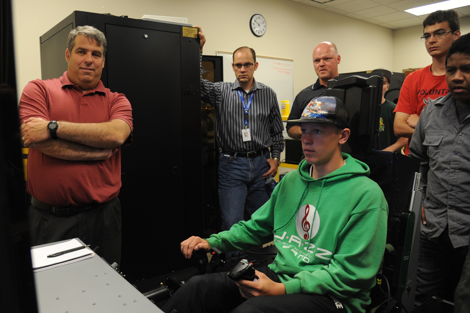 A student from Spokane Community College tries the aircraft piloting simulator during a base tour at Fairchild Air Force Base, Washington, July 2, 2014. The students received a base tour with stops at aerospace physiology, the control tower, a rescue helicopter static display, the base headquarters and the KC-135 Stratotanker flight simulator.  (U.S. Air Force photo by Airman 1st Class Janelle Patiño/Released)