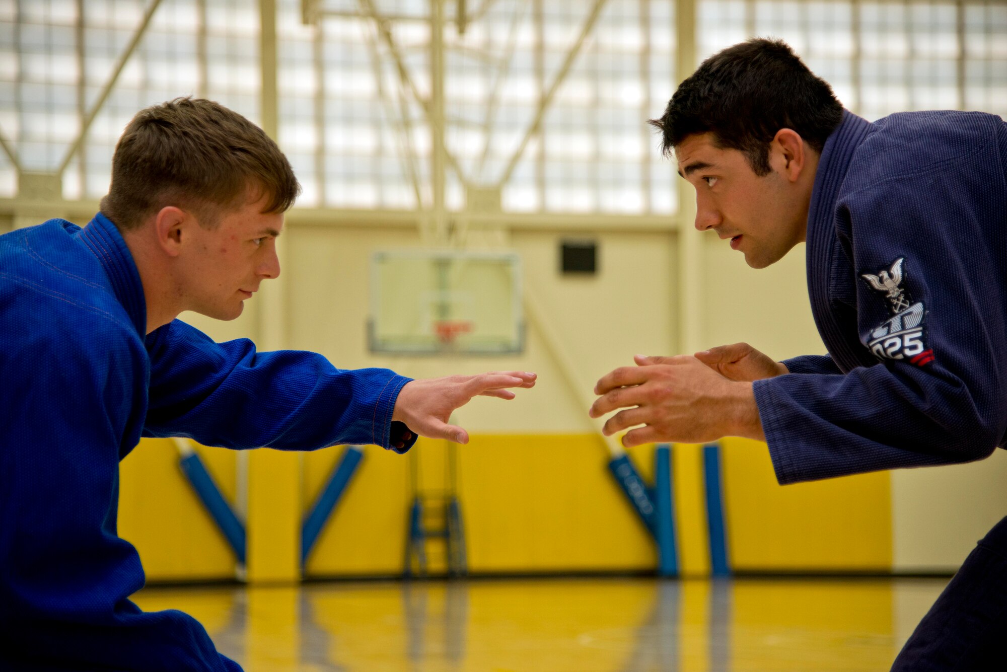 Senior Airman Seth Lindquist, 60th Civil Engineer Squadron, and Senior
Airman Jared Morley, 60th Force Support Squadron, prepare to grapple
and demonstrate various jiu-jitsu moves that can be used to bring the
opponent to submission.