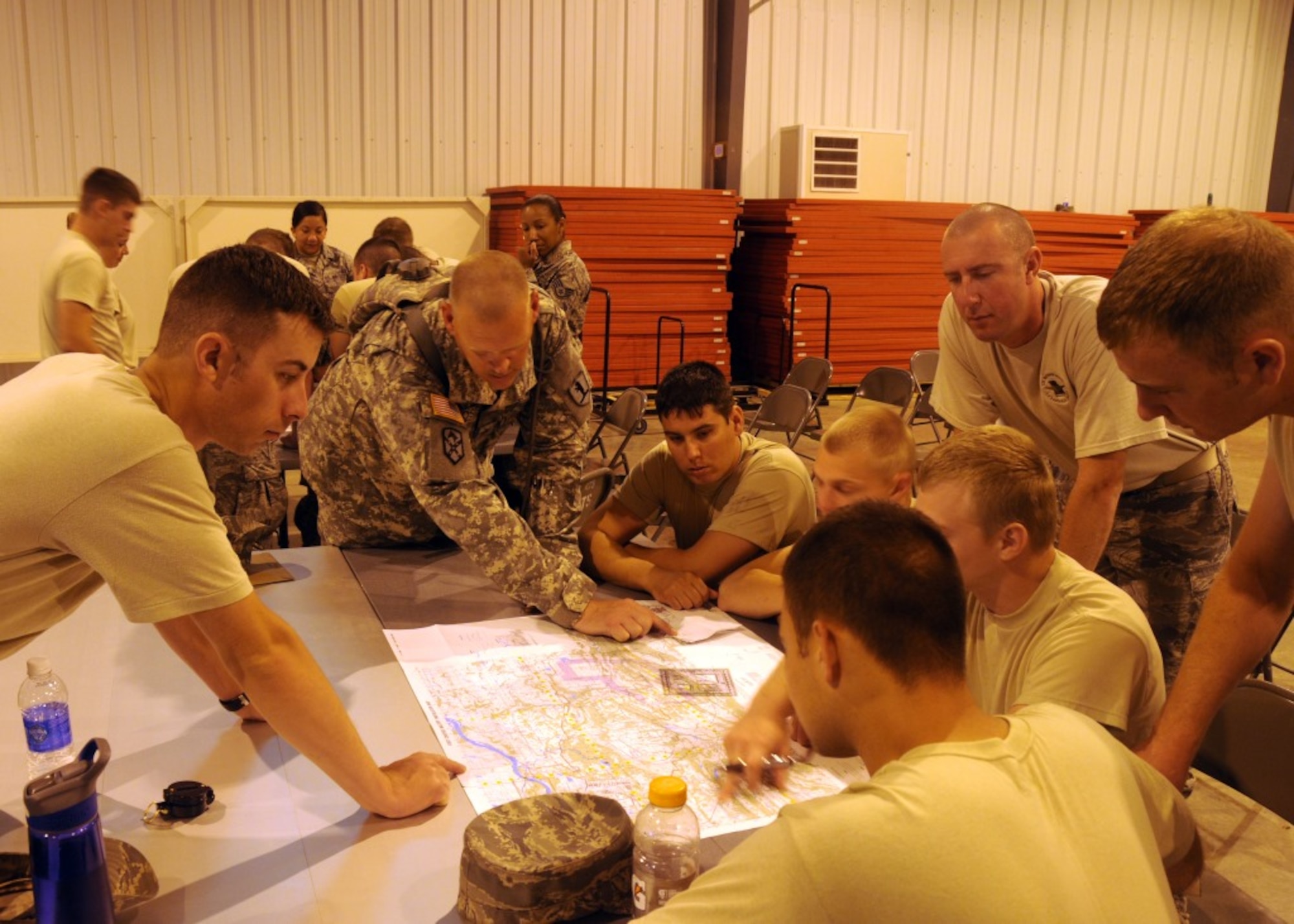 Missouri Army National Guard Sgt. Daniel Moses, driver with the 1138th Transportation Company, instructs members of the Missouri Air National Guard’s 131st Maintenance Group on map-reading and orienteering skills during a joint training session at Camp Clark in Nevada, Missouri, on June 17, 2014. Airmen with the 131st worked closely with Moses and other Soldiers throughout week-long training designed to prepare for state emergency duty. (U.S. Air National Guard photo by Senior Airman Nathan Dampf/RELEASED)