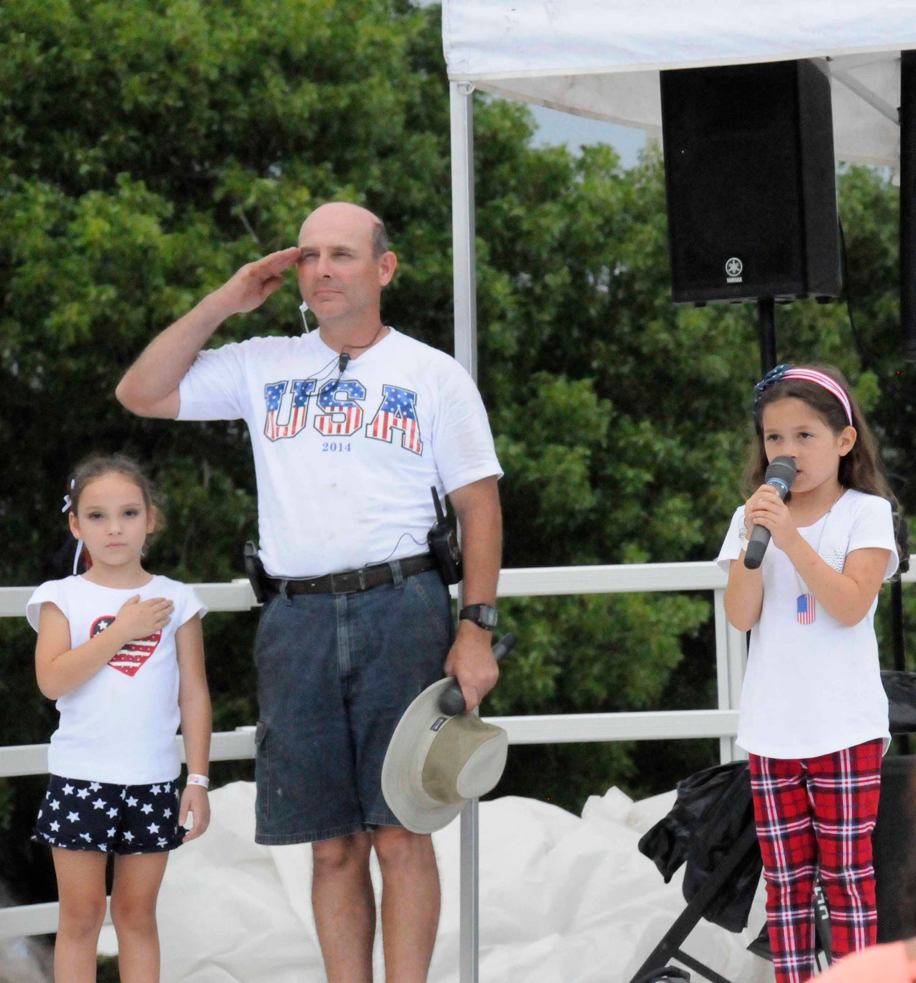 Seven-year-old Isabelle Alaina Simpson, daughter of Staff Sgt. Veronica Simpson, sings the National Anthem during the 5th Annual Independence Day Celebration at Homestead Air Reserve Base, Fla., on July 4. (U.S. Air Force photo/Senior Airman Aja Heiden)