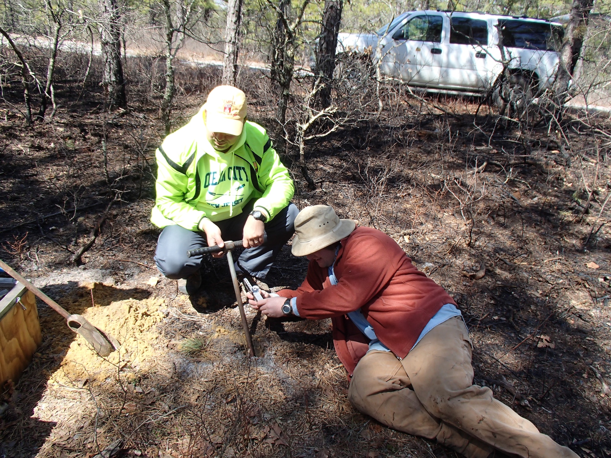 From left, Dr. Ilya Buynevich, an assistant professor of earth sciences at Temple University, and Logan Wiest, a graduate student at Temple, construct experimental inclined shafts for georadar imaging. The imaging is used to compare the artificial shafts to natural northern pine snake burrows and is part of an effort to map the hibernations habitats of the threatened snake and help recover the population in New Jersey. (Courtesy photo/Dane Ward, Laboratory of Pinelands Research, Drexel University)