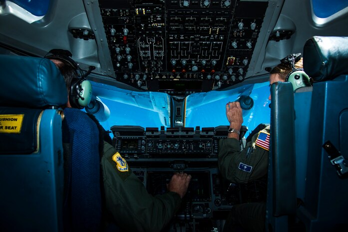 Col. Fred Boehm, 437th Operations Group commander (left), and Lt. Col. Debi Rieflin, 315th Operations Group aircrew training chief, perform an in-flight refueling exercise July 1, 2014. Boehm and Rieflin were both members of the initial cadre of C-17 pilot teams that flew C-17s to Charleston Air Base more than 20 years ago, and were also participating in Col. Tony Schenk’s ‘fini flight,’ an aviation tradition in which aircrew members are met by their unit comrades, family and friends and soaked with water after completing their final flight with their unit.  (U.S. Air Force photo/ Airman 1st Class Clayton Cupit)
