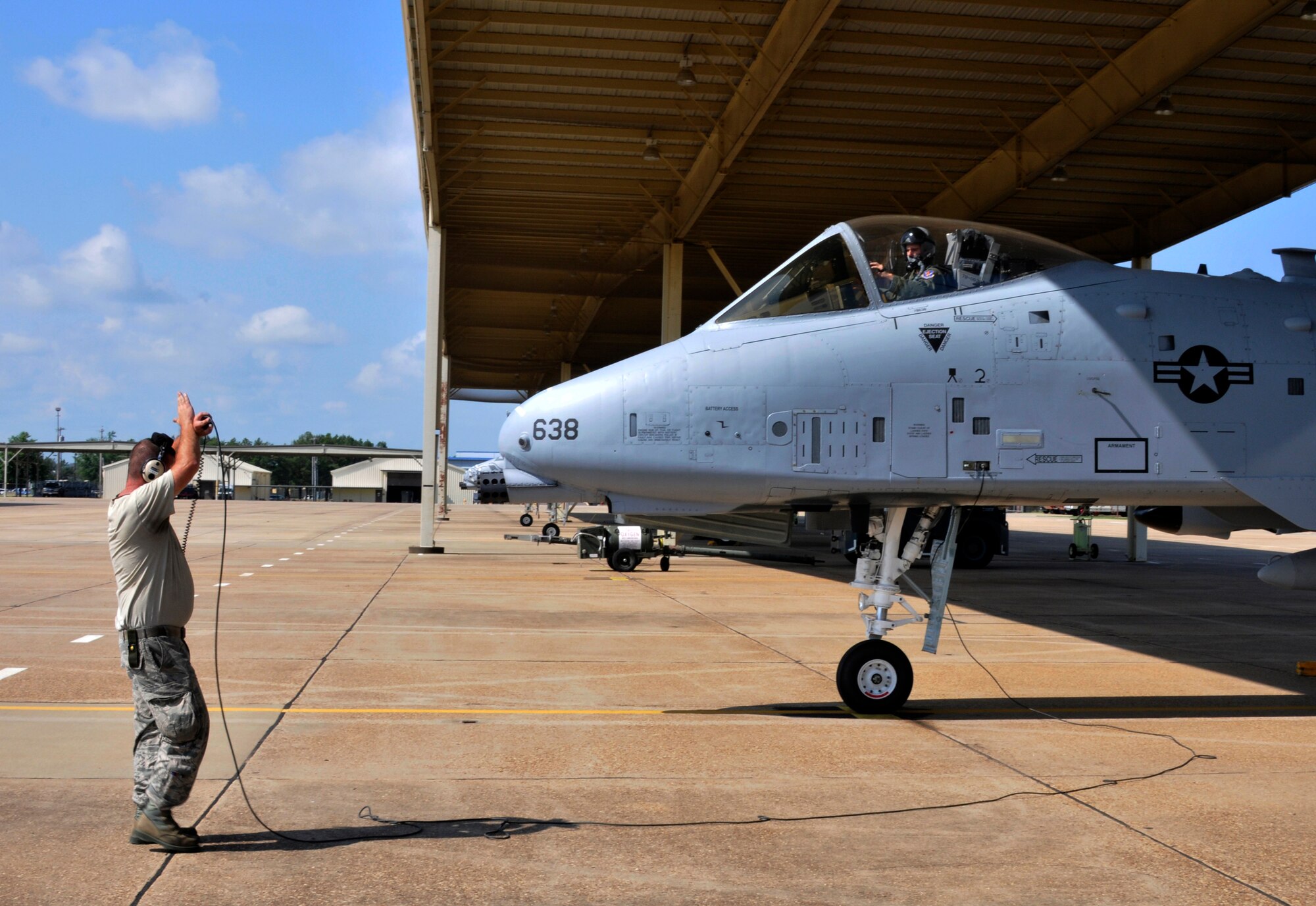 Master Sgt. Mike Kolb, a crew chief with the former 188th Aircraft Maintenance Squadron, marshals 1st Lt. Kyle Adkison and his A-10C Thunderbolt II "Warthog" aircraft, Tail No. 638, at Ebbing Air National Guard Base, Fort Smith, Arkansas, June 3, 2014. The pilot transported the A-10 to Moody Air Force Base, Georgia as part of the 188th Wing's conversion to a remotely piloted aircraft/intelligence, surveillance and reconnaissance mission. (U.S. Air National Guard photo by Airman 1st Class Cody Martin/Released)