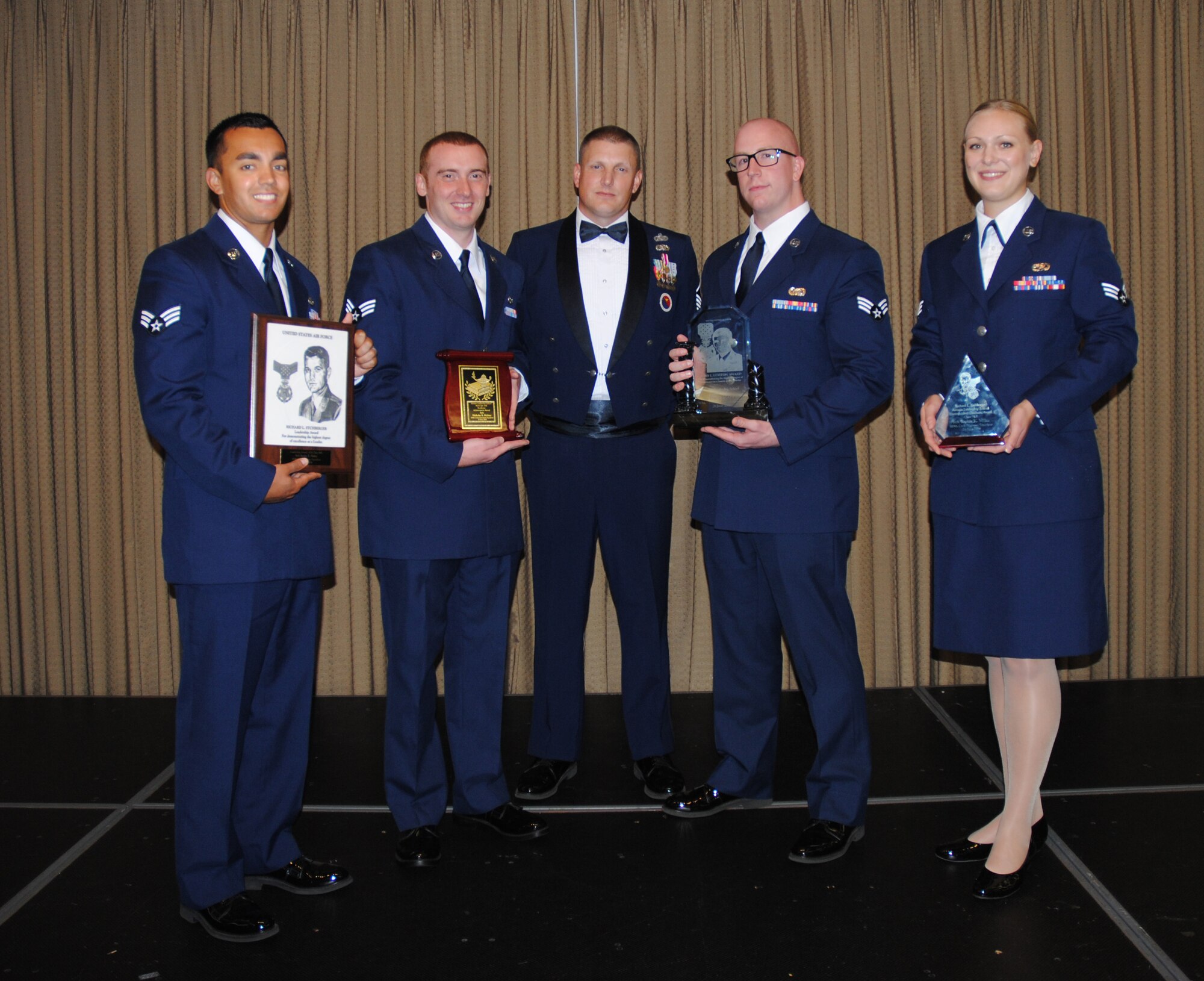 Chief Master Sgt. Richard L. Etchberger Airman Leadership School commadant, Maaster Sgt. Aaron Holmes poses for a group photo with the award recipients of Class 14-Echo after a graduation ceremony held June 26, 2014, at the Northern Lights Club on Grand Forks Air Force Base, N.D. Class 14-E was made up by two 12 active-duty Airmen completing their in-residence course at the Etchberger ALS in Grand Forks AFB, and a dozen Air National Guard Airmen from the 119th Wing attending an in-residence ALS course at the North Dakota ANG base in Fargo, N.D. This new approach on training resulted in class winners from both the active-duty and ANG units. (U.S. Air Force photo/Staff Sgt. Luis Loza Gutierrez)