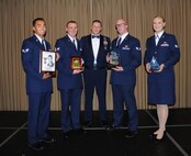 Chief Master Sgt. Richard L. Etchberger Airman Leadership School commadant, Maaster Sgt. Aaron Holmes poses for a group photo with the award recipients of Class 14-Echo after a graduation ceremony held June 26, 2014, at the Northern Lights Club on Grand Forks Air Force Base, N.D. Class 14-E was made up by two 12 active-duty Airmen completing their in-residence course at the Etchberger ALS in Grand Forks AFB, and a dozen Air National Guard Airmen from the 119th Wing attending an in-residence ALS course at the North Dakota ANG base in Fargo, N.D. This new approach on training resulted in class winners from both the active-duty and ANG units. (U.S. Air Force photo/Staff Sgt. Luis Loza Gutierrez)