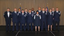 Chief Master Sgt. Richard L. Etchberger Airman Leadership School Class 14-Echo (active-duty members) pose for a group photo with their ALS instructor and class mentor moments before a graduation ceremony held June 26, 2014, at the Northern Lights Club on Grand Forks Air Force Base, N.D. Class 14-E was made up by two groups of students more commonly referred to in the Air Force as flights. One flight consisted of 12 active-duty Airmen completing their in-residence course at the Etchberger ALS in Grand Forks AFB, while the other flight was made up of a dozen Air National Guard Airmen from the 119th Wing attending an in-residence ALS course at the North Dakota ANG base in Fargo, N.D. Both of the flights were simultaneously taught by Air Force active-duty instructors from the Etchberger ALS. This new approach on training was the first of its kind according to officials from the 119th Wing and the 319th Air Base Wing. (U.S. Air Force photo/Staff Sgt. Luis Loza Gutierrez)