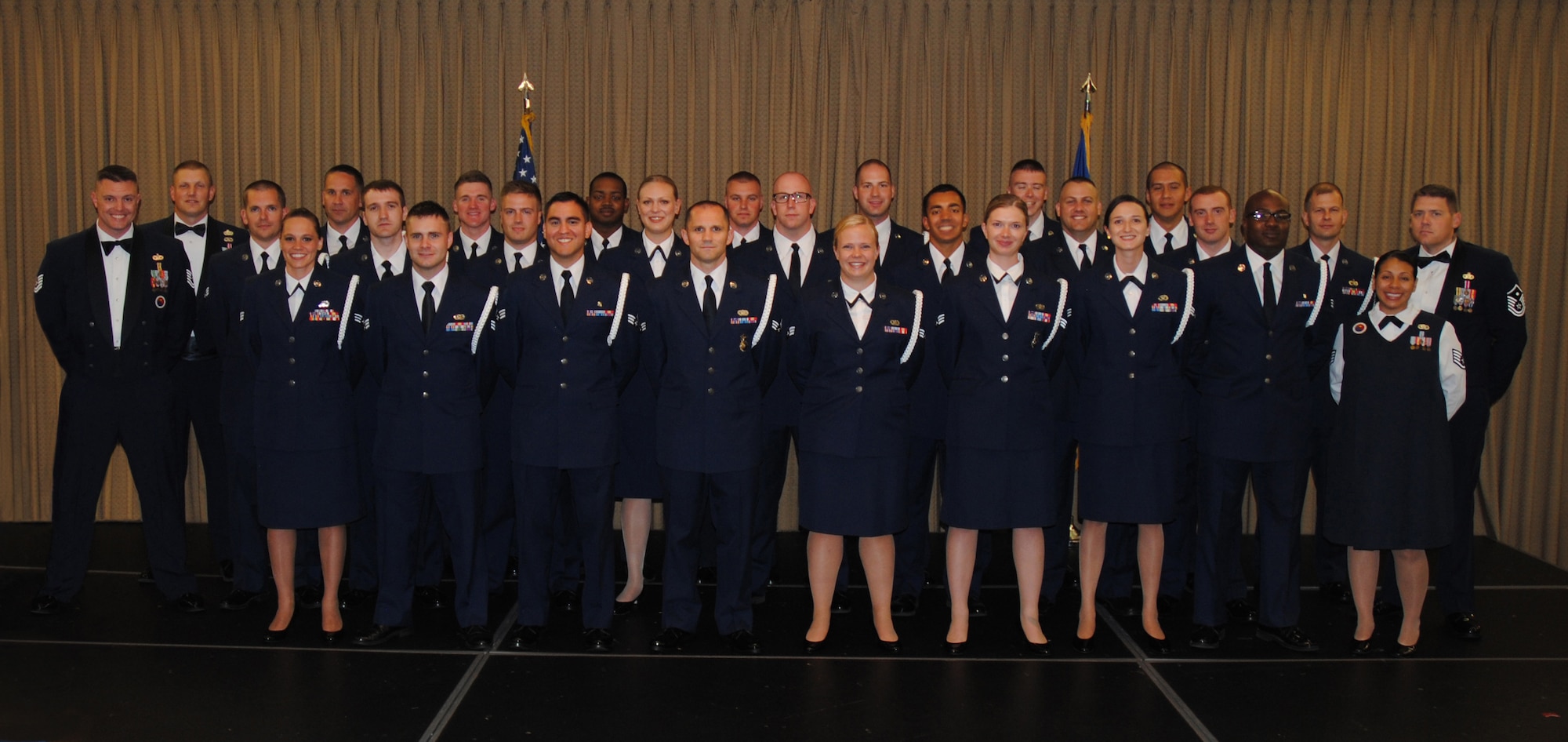 The commandant and instructors from the Chief Master Sgt. Richard L. Etchberger Airman Leadership School pose for a group photo with members of ALS Class 14-Echo and their class mentor moments before a graduation ceremony held June 26, 2014, at the Northern Lights Club on Grand Forks Air Force Base, N.D. Class 14-E was made up by two groups of students more commonly referred to in the Air Force as flights. One flight consisted of 12 active-duty Airmen completing their in-residence course at the Etchberger ALS in Grand Forks AFB, while the other flight was made up of a dozen Air National Guard Airmen from the 119th Wing attending an in-residence ALS course at the North Dakota ANG base in Fargo, N.D. Both of the flights were simultaneously taught by Air Force active-duty instructors from the Etchberger ALS. This new approach on training was the first of its kind according to officials from the 119th Wing and the 319th Air Base Wing. (U.S. Air Force photo/Staff Sgt. Luis Loza Gutierrez)