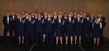 The commandant and instructors from the Chief Master Sgt. Richard L. Etchberger Airman Leadership School pose for a group photo with members of ALS Class 14-Echo and their class mentor moments before a graduation ceremony held June 26, 2014, at the Northern Lights Club on Grand Forks Air Force Base, N.D. Class 14-E was made up by two groups of students more commonly referred to in the Air Force as flights. One flight consisted of 12 active-duty Airmen completing their in-residence course at the Etchberger ALS in Grand Forks AFB, while the other flight was made up of a dozen Air National Guard Airmen from the 119th Wing attending an in-residence ALS course at the North Dakota ANG base in Fargo, N.D. Both of the flights were simultaneously taught by Air Force active-duty instructors from the Etchberger ALS. This new approach on training was the first of its kind according to officials from the 119th Wing and the 319th Air Base Wing. (U.S. Air Force photo/Staff Sgt. Luis Loza Gutierrez)