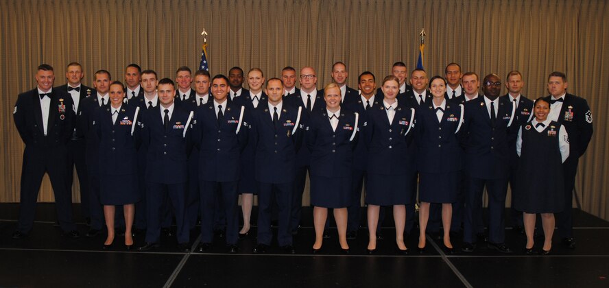 The commandant and instructors from the Chief Master Sgt. Richard L. Etchberger Airman Leadership School pose for a group photo with members of ALS Class 14-Echo and their class mentor moments before a graduation ceremony held June 26, 2014, at the Northern Lights Club on Grand Forks Air Force Base, North Dakota. Class 14-E was made up by two groups of students more commonly referred to in the Air Force as flights. One flight consisted of 12 active-duty Airmen completing their in-residence course at the Etchberger ALS in Grand Forks AFB, while the other flight was made up of a dozen Air National Guard Airmen from the 119th Wing attending an in-residence ALS course at the North Dakota ANG base in Fargo, North Dakota. Both of the flights were simultaneously taught by Air Force active-duty instructors from the Etchberger ALS. This new approach on training was the first of its kind according to officials from the 119th Wing and the 319th Air Base Wing. (U.S. Air Force photo/Staff Sgt. Luis Loza Gutierrez) 

