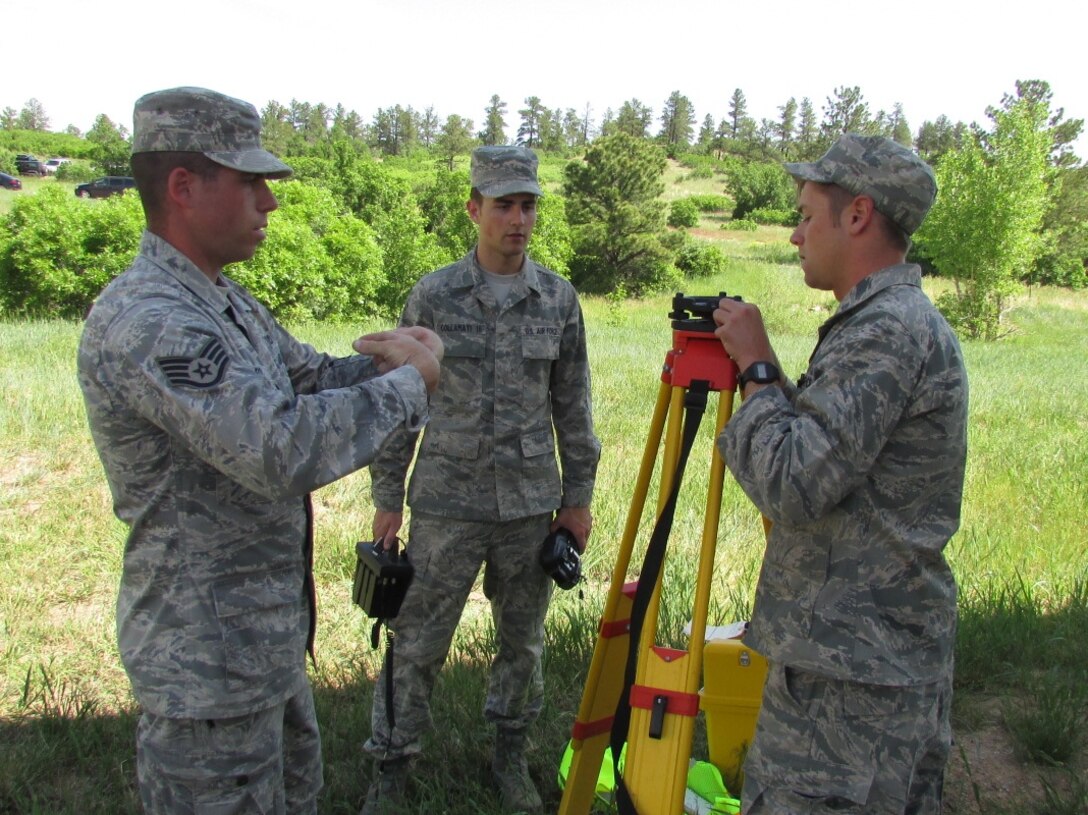 Staff Sgt. Christopher Fox, 914th Civil Engineer Squadron, engineering assistant, instructs Air Force Academy Cadets on surveying procedures at the Field Engineering & Readiness Laboratory site located at the USAFA, Colorado Springs, Colorado on June 9, 2014. The 914 CES traveled to the USAFA for annual tour training and mentored more than 60 cadets with instruction and hands-on training. (U.S. Air Force photo bu Senior Master Sgt. Michael Haag)