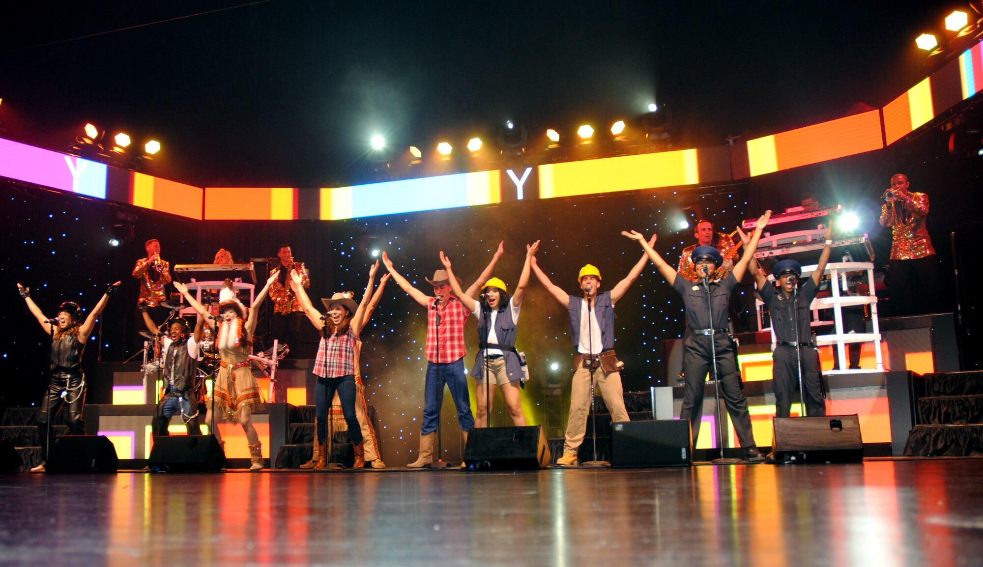 Air Force Tops in Blue members perform their rendition of the 1970's hit,  "Y.M.C.A." by the Village People, which was performed live June 29, 2014, at the Chester Fritz Auditorium on the campus grounds of the University of North Dakota in Grand Forks, N.D. Male and female performers took part in the musical number. (U.S. Air Force photo/Staff Sgt. Luis Loza Gutierrez)