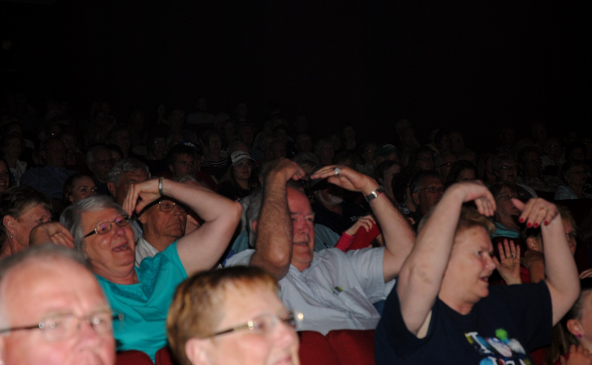 Audience members get groovy during the Air Force Tops in Blue's rendition of the 1970's hit,  "Y.M.C.A." by the Village People, which was performed live June 29, 2014, at the Chester Fritz Auditorium on the campus grounds of the University of North Dakota in Grand Forks, N.D. Audience participation is a staple of Tops in Blue performances. (U.S. Air Force photo/Staff Sgt. Luis Loza Gutierrez)