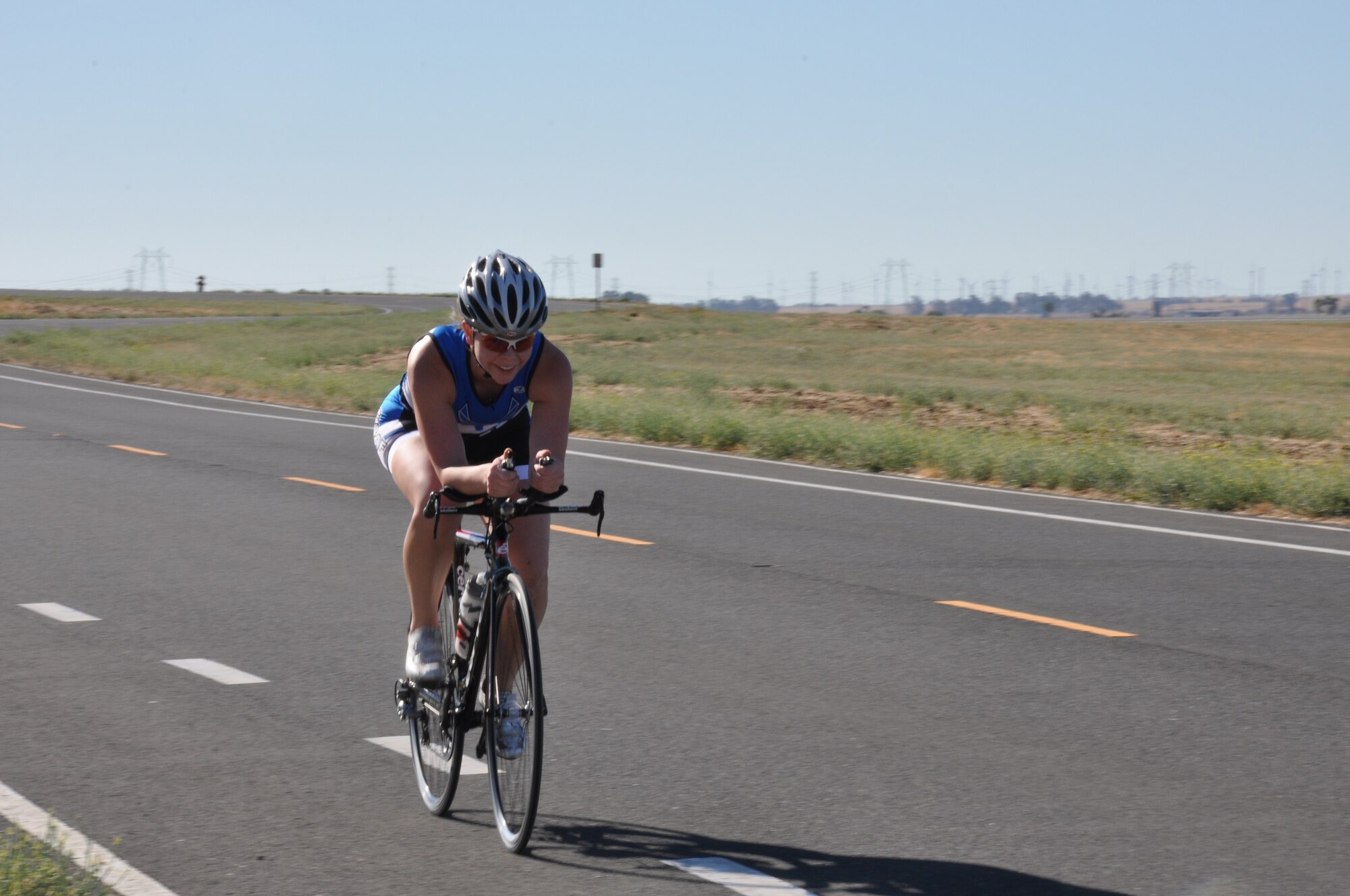 A participant pedals her way toward the Aquatic Center from Perimeter Road. The 12-mile bike ride was the second obstacle to complete during the triathlon. 