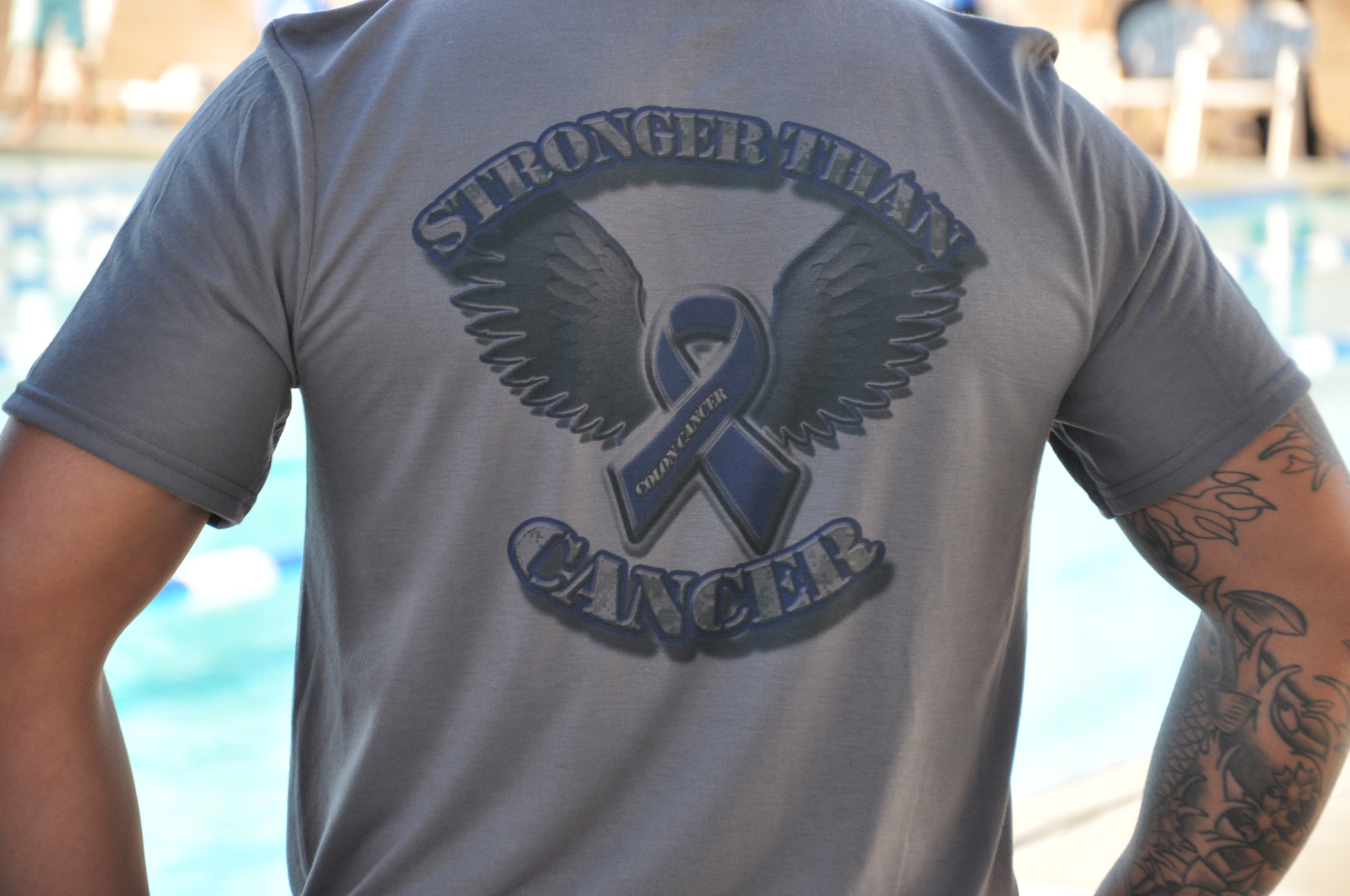 A participant of the cancer survivor team displays his team's T-shirt. The Gotta Tri Triathlon competitors participated in single or team competition. 