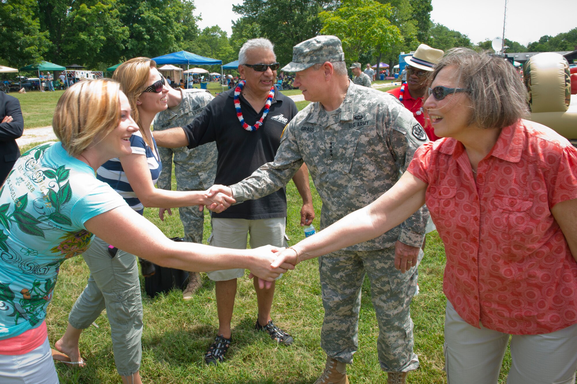 U.S. Army Gen. Frank J. Grass, chief of the National Guard Bureau, and his wife Patricia (right) greets attendees during the annual ANGRC picnic at Fort Hunt Park near Alexandria, Virginia July 3, 2014. The event provides an opportunity to build morale, teamwork and recognize the sacrifices and contributions of ANG families to the Total Force mission. (Air National Guard photo by Master Sgt. Marvin R. Preston/Released)