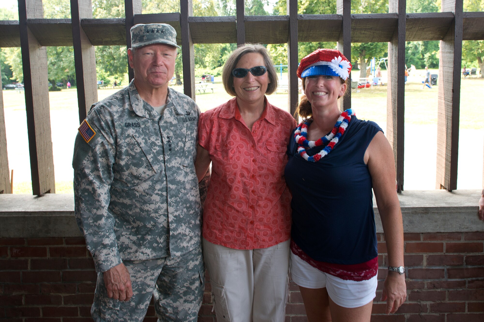 U.S. Army Gen. Frank J. Grass, chief of the National Guard Bureau, and his wife Patricia (center) poses for a photo with Air Force Senior Master Sgt. Harmony Thomas during the annual ANGRC picnic at Fort Hunt Park near Alexandria, Virginia July 3, 2014. The event provides an opportunity to build morale, teamwork and recognize the sacrifices and contributions of ANG families to the Total Force mission. (Air National Guard photo by Master Sgt. Marvin R. Preston/Released)