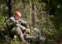An Army Ranger student takes a breather during a moment of down time prior to a field training exercise in the woods of the Eglin Air Force Base, Fla., range.  Students complete the final phase of the Army Ranger course with the 6th Ranger Training Battalion.  Instructors expose the students to an 18-day field training that includes airborne and helicopter assaults, small boat operations, river and swamp crossings. (U.S. Air Force photo/Tech. Sgt. Samuel King Jr.)