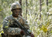 An Army Ranger student scans the treeline while on watch duty in the woods of the Eglin Air Force Base, Fla., range.  Students complete the final phase of the Army Ranger course with the 6th Ranger Training Battalion.  Instructors expose the students to an 18-day field training that includes airborne and helicopter assaults, small boat operations, river and swamp crossings. (U.S. Air Force photo/Tech. Sgt. Samuel King Jr.)