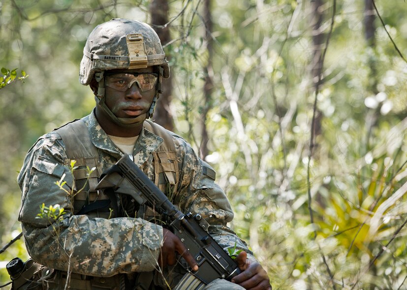 An Army Ranger student scans the treeline while on watch duty in the woods of the Eglin Air Force Base, Fla., range.  Students complete the final phase of the Army Ranger course with the 6th Ranger Training Battalion.  Instructors expose the students to an 18-day field training that includes airborne and helicopter assaults, small boat operations, river and swamp crossings. (U.S. Air Force photo/Tech. Sgt. Samuel King Jr.)