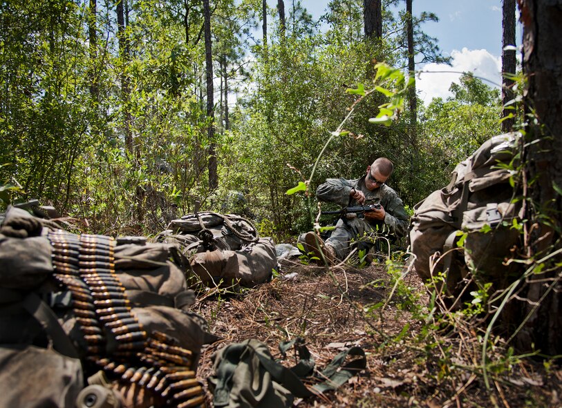 An Army Ranger student cleans his weapon during some down time in the woods of the Eglin Air Force Base, Fla., range.  Students complete the final phase of the Army Ranger course with the 6th Ranger Training Battalion.  Instructors expose the students to an 18-day field training that includes airborne and helicopter assaults, small boat operations, river and swamp crossings.  (U.S. Air Force photo/Tech. Sgt. Sam King)
