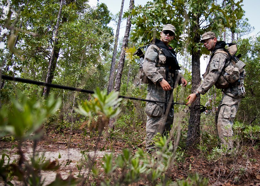 Army Ranger students practice their rope tying procedures prior to a river crossing during a field training exercise in the woods of the Eglin Air Force Base, Fla., range.  Students complete the final phase of the Army Ranger course with the 6th Ranger Training Battalion.  Instructors expose the students to an 18-day field training that includes airborne and helicopter assaults, small boat operations, river and swamp crossings. (U.S. Air Force photo/Tech. Sgt. Samuel King Jr.)