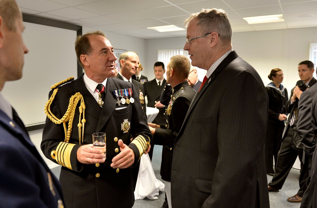 U.S. Deputy Defense Secretary Bob Work, right, talks with British Adm. Sir George Zambellas, first sea lord and the British Royal Navy’s chief of naval staff, during a reception before the HMS Queen Elizabeth ship naming ceremony in Rosyth, Scotland, July 4, 2014. The ship is Britain’s newest aircraft carrier.  