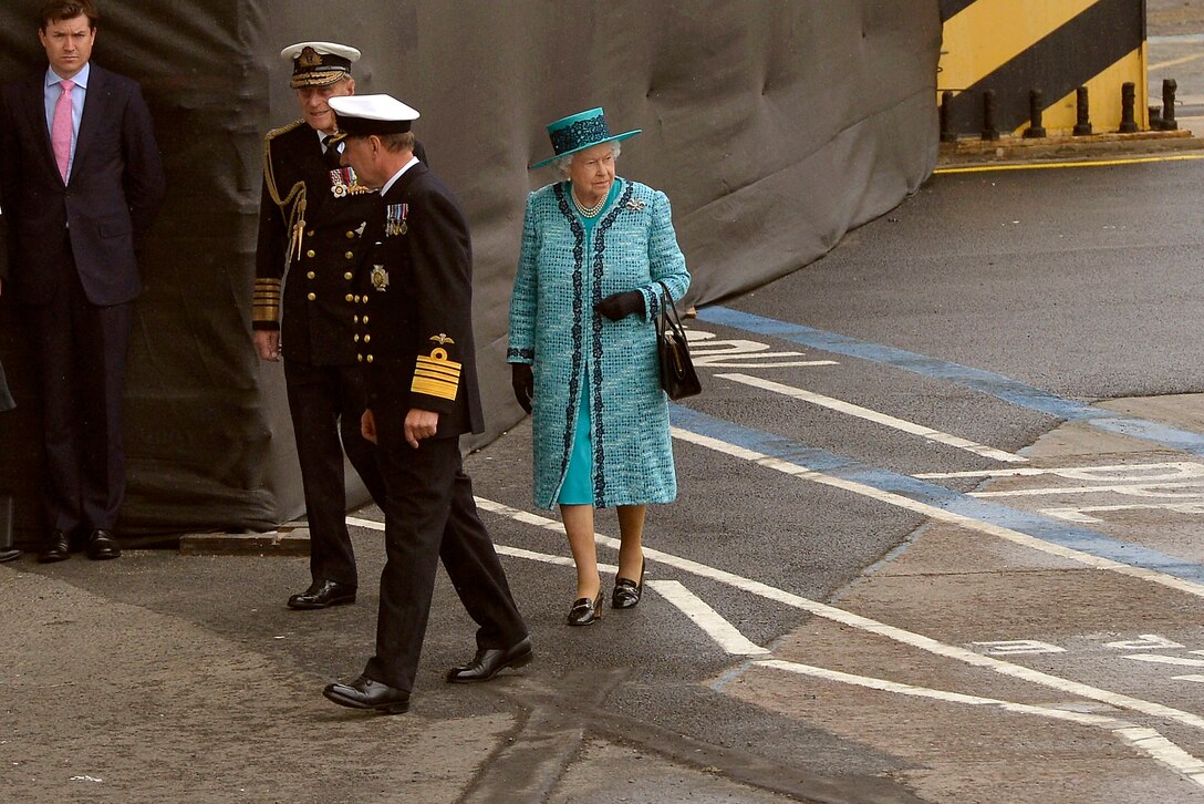 Queen Elizabeth II takes a glance in the direction of the HMS Queen Elizabeth, the Royal Navy's newest aircraft carrier, as she arrives to attend a christening ceremony of the ship in Rosyth, Scotland, July 4, 2014.