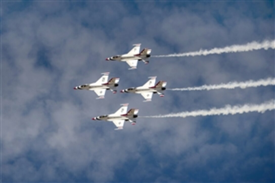 The Air Force Thunderbirds air demonstration team perform precision stunts during the Warriors Over the Wasatch airshow over Hill Air Force Base, Utah, June 28, 2014. The show included aeronautical performances from the Army Golden Knights, an F-16 attack demonstration by the 388th Fighter Wing, as well as a precision air demonstration by the Air Force Thunderbirds air demonstration team.