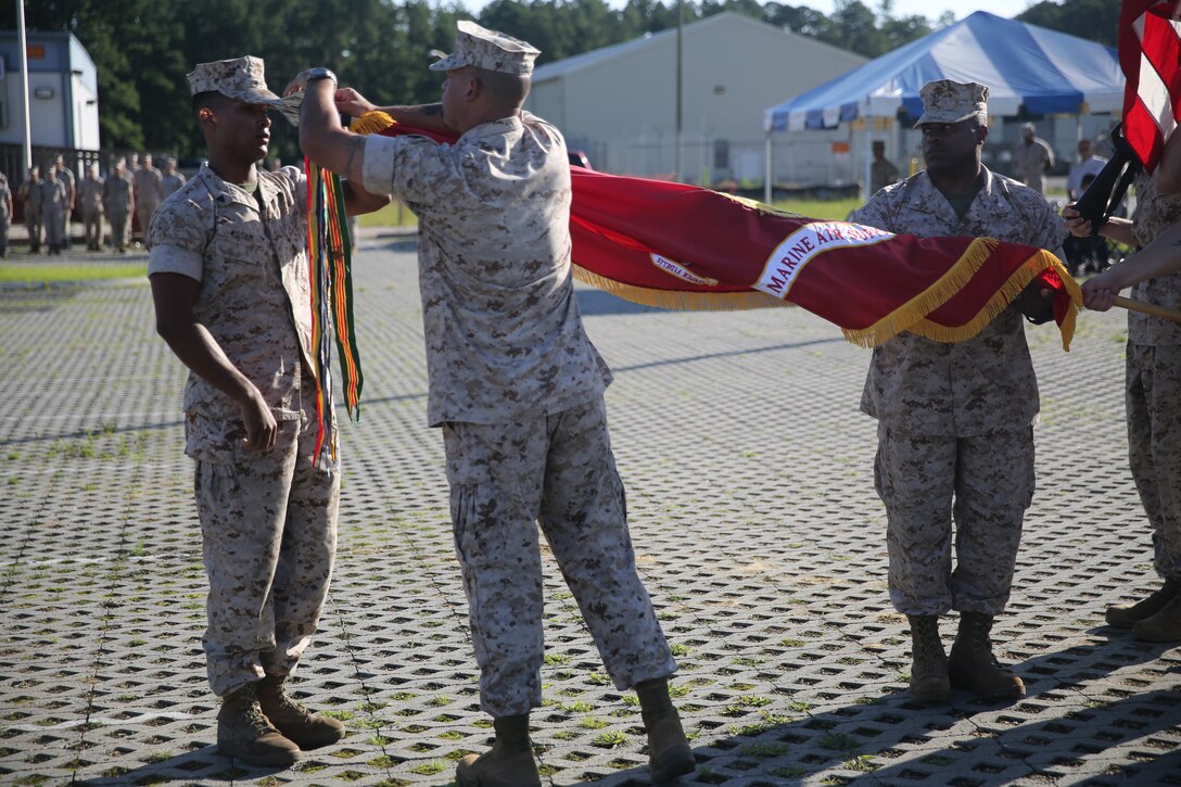 Lieutenant Col. AnDroy D. Senegar (right) Sgt. Maj. Monroe C. Boykin (center) and Cpl. Marcus D. Kissam re-affix a battle streamer on Marine Air Support Squadron 1’s colors during the squadron’s birthday celebration at Marine Corps Air Station Cherry Point, N.C., July 1, 2014. “The importance of re-affixing the streamers is to reaffirm what we have done and the blood that was shed for our great institution,” said Senegar, the squadron’s commanding officer. Boykin is MASS-1’s sergeant major and Kissam is a refrigeration and air conditioning technician with the squadron.


