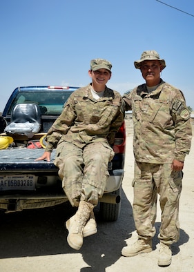 Senior Airman Kimberly Buzzell, left, and Tech. Sgt. John Trujillo, pose for a photograph July 1, 2014, at Bagram Airfield, Afghanistan.  The father and daughter team, originally fromTurner, Maine, is assigned to Task Force Signal and deployed together from the Air National Guard’s 243rd Engineering Installation Squadron in South Portland, Maine. Trujillo is a cable and antenna team chief while Buzzell is a radio frequency transmissions technician. (U.S. Air Force photo/Staff Sgt. Evelyn Chavez)