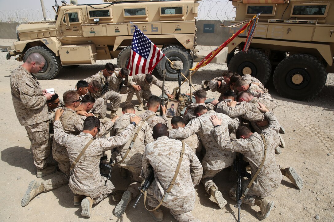Marines with Scout Sniper Platoon, 1st Battalion, 7th Marine Regiment, gather for a final prayer around a battlefield cross after a memorial ceremony aboard Camp Leatherneck, July 2, 2014. The memorial was in honor of Sgt. Thomas Z. Spitzer, a professionally instructed gunman with Scout Sniper Platoon, 1st Bn., 7th Marines, who was killed while conducting combat operations in Helmand province, Afghanistan, June 25, 2014.
(U.S. Marine Corps photo by Cpl. Joseph Scanlan / released)
