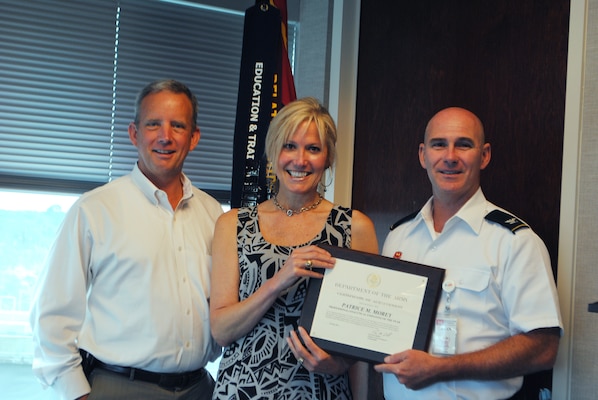 Eric Bush, chief of the Planning and Policy Division (left) and Col. Alan Dodd, district commander (right) present Patrice Morey with the 2014 Professional Analytical Employee of the Year award. “Patrice demonstrates the highest personal standards of quality and integrity,” said Bush. 