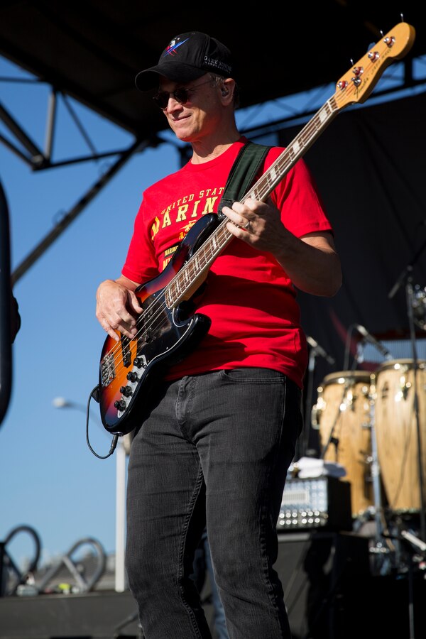 MARINE CORPS AIR STATION MIRAMAR, Calif. – Gary Sinise, actor and musician with the Lt. Dan Band, plays bass guitar with his band during a concert aboard Marine Corps Air Station Miramar, Calif., July 7. Sinise travels the world with his band to support service members and families. 