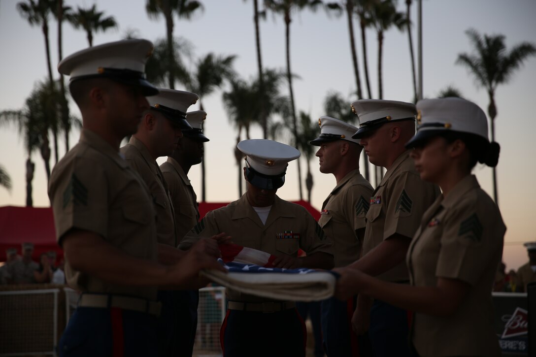 MARINE CORPS AIR STATION MIRAMAR, Calif. – Noncommissioned officers with Marine Aircraft Group (MAG) 16 fold an American flag at the end of a colors ceremony aboard Marine Corps Air Station Miramar, Calif., July 7. The NCOs organized the colors ceremony along with a live performance by Gary Sinise and the Lt. Dan Band for service members and families aboard the air station. 