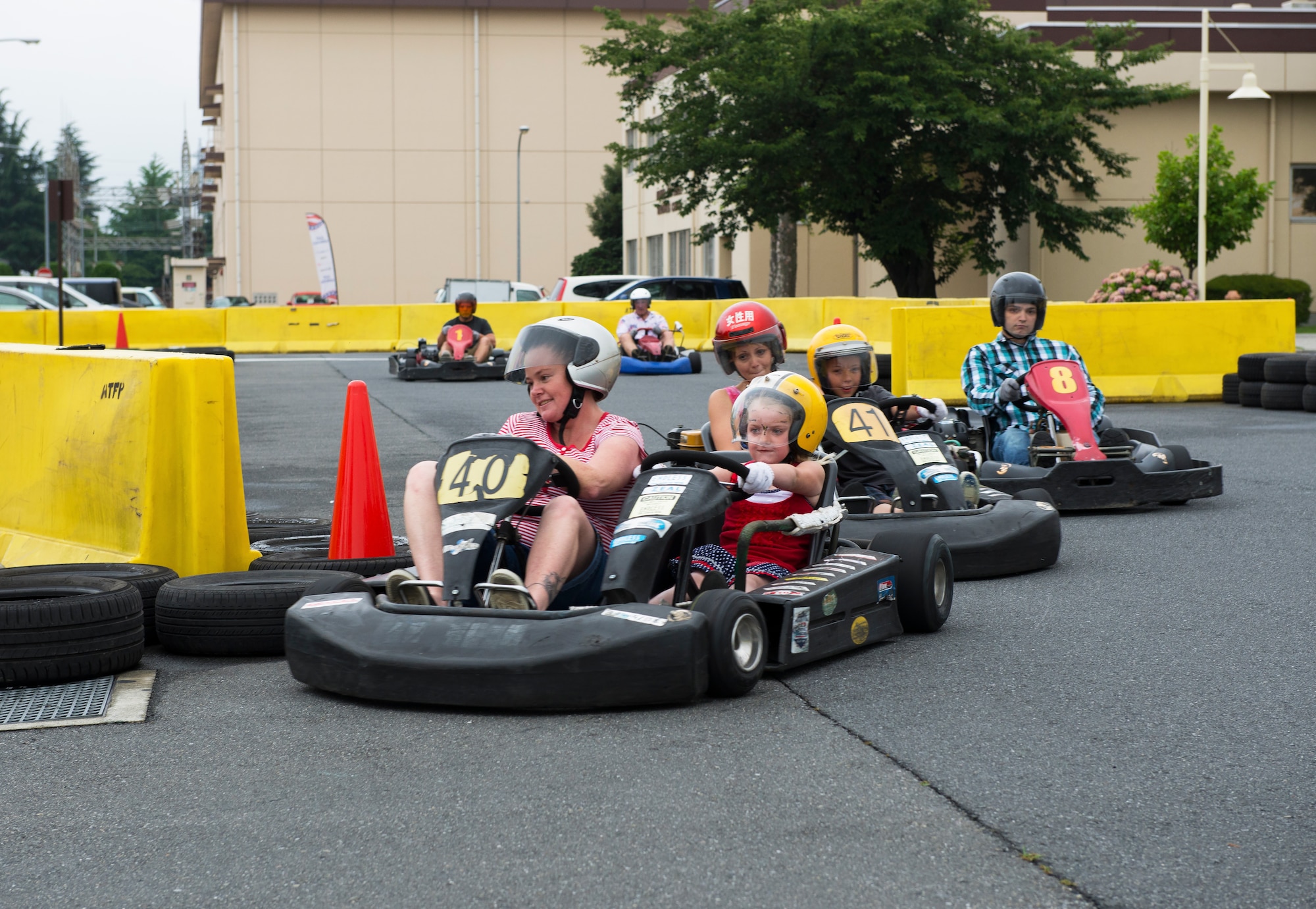 Members of Team Yokota race around the corner of a go-kart track as part of Celebrate America, a daylong 4th of July event coordinated by the 374th Force Support Squadron to celebrate Independence Day at Yokota Air Base, Japan.  The annual event included the go-karts, pony rides, numerous games and food booths, live music and finished off with a fireworks show.  (U.S. Air Force photo by Tech. Sgt. Christopher Marasky)