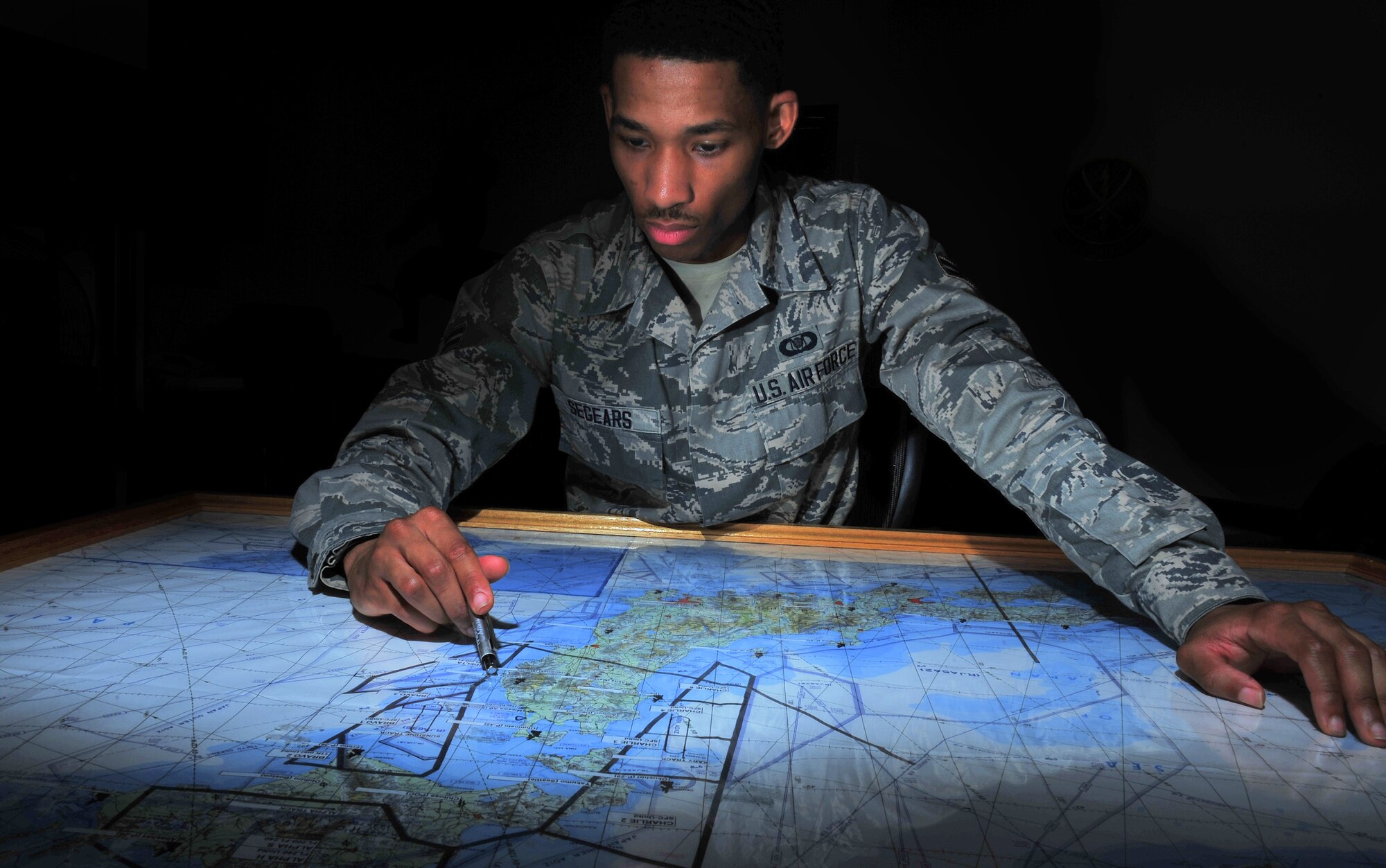 U.S. Air Force Airman 1st Class Ian Segears, 610th Air Control Flight weapons director technician, reviews quadrants of the Japanese Airspace, July 2, 2014. As part of his job is he is entrusted with providing fighter pilots with tactical airspace information during flight operations across the Asia-Pacific region. (U.S. Air Force photo/Senior Airman Jose L. Hernandez-Domitilo)  