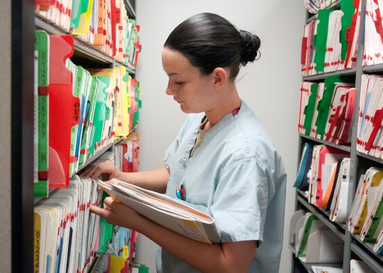 Airman 1st Class Whitney Erickson, 90th Medical Group dental assistant, searches for medical records July 8, 2014, at the 90th MDG Medical Treatment Facility on F.E. Warren Air Force Base, Wyo. The 90th Medical Group is an outpatient clinic which offers a variety of care, ensuring excellent health and welfare of all beneficiaries. (U.S. Air Force photo by Airman Malcolm Mayfield)