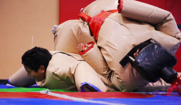 Kapaka (red) participates in a sumo wrestling battle with his brother Ma’ila (blue) during Freedom Fest July 3, 2014 at Nellis Air Force Base Nev. The sumo wrestling was one of the many events provided during the Freedom Fest to encourage family and friends to wind down and have fun in celebration of the upcoming holiday weekend. (U.S. Air Force photo by Airman 1st Class Rachel Loftis)