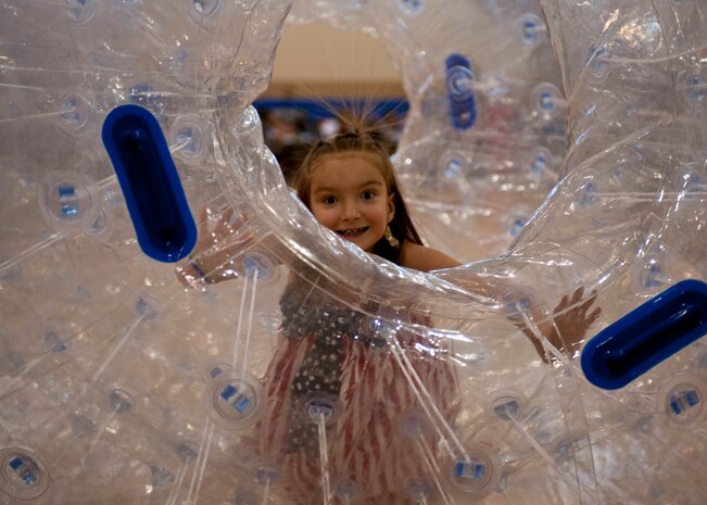 Kelly rolls across the Warrior Fitness Center’s basketball court in an inflatable sphere during Freedom Fest July 3, 2014 at Nellis Air Force Base Nev. The Freedom Fest, hosted by the 99th Force Support Squadron, included face painting, hula lessons, inflatable play areas and food. (U.S. Air Force photo by Senior Airman Timothy Young)