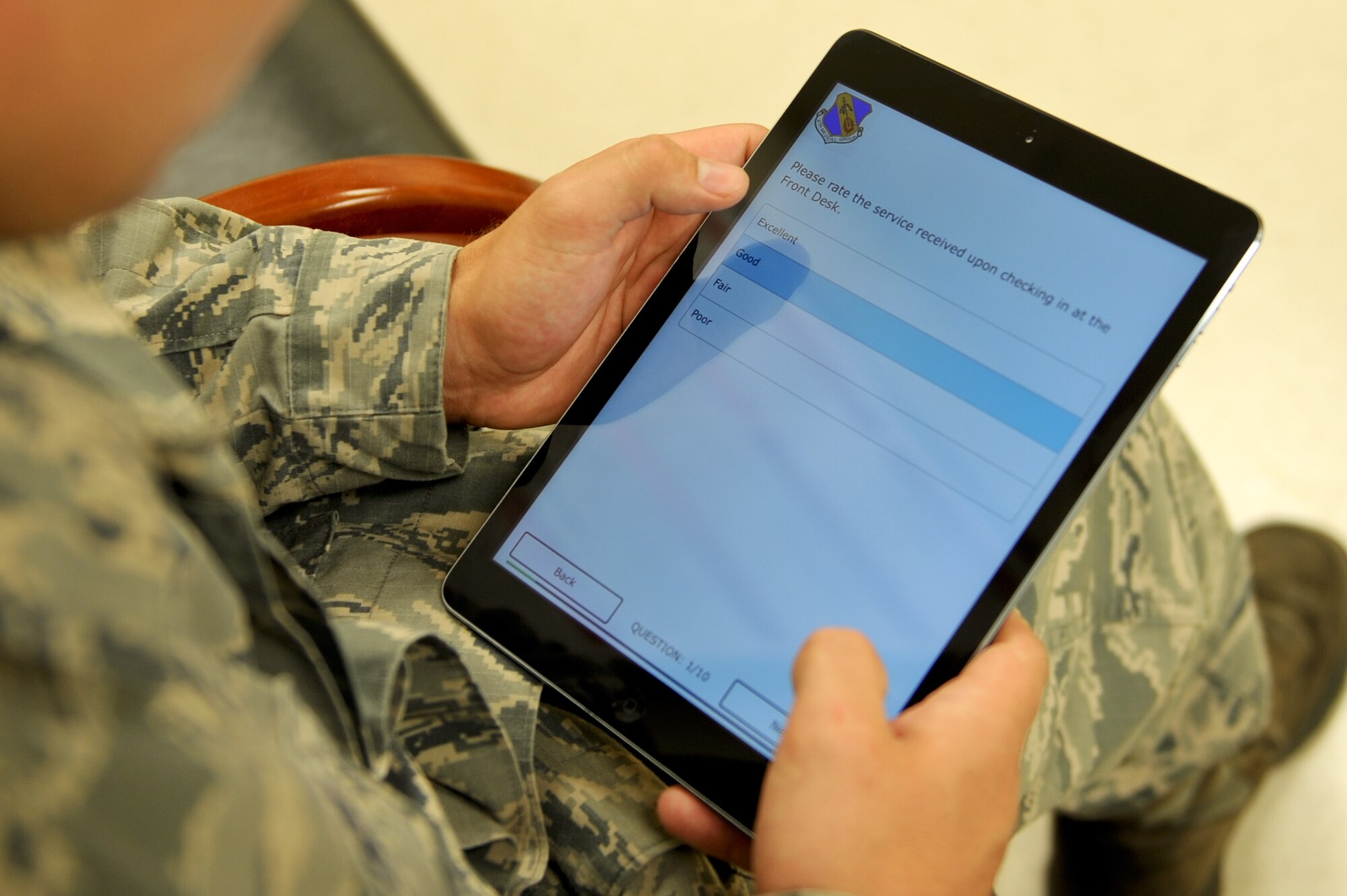 Senior Airman Donald Templeton, 4th Aircraft Maintenance Squadron load crew member, completes a survey after a medical appointment July 2, 2014, at Seymour Johnson Air Force Base, North Carolina. The 4th Medical Group is testing a new tablet-based customer survey app to provide consumer friendly, real-time feedback with a survey adaptable to fit group needs. (U.S. Air Force photo/Airman 1st Class Aaron J. Jenne)